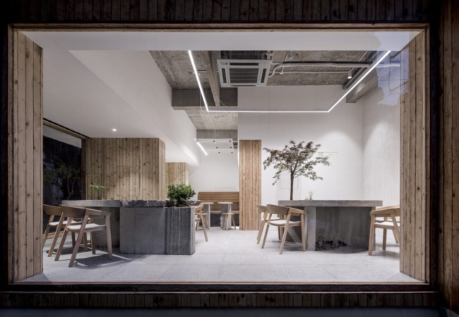 Plants grow from fractured concrete at dessert restaurant in Shanghai