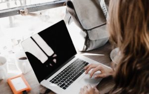 Woman working in cafe on laptop