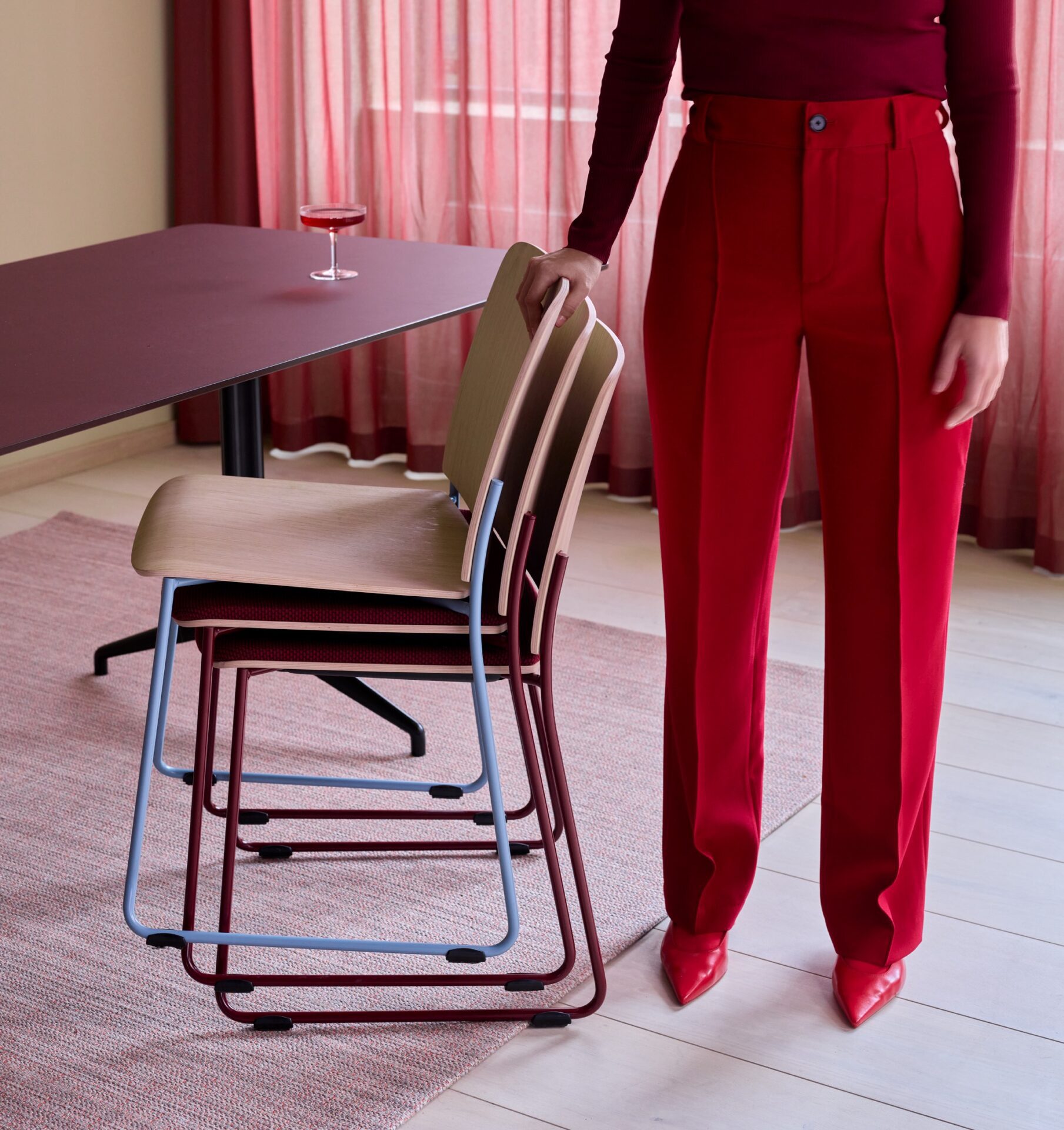 Woman standing with a stack of chairs