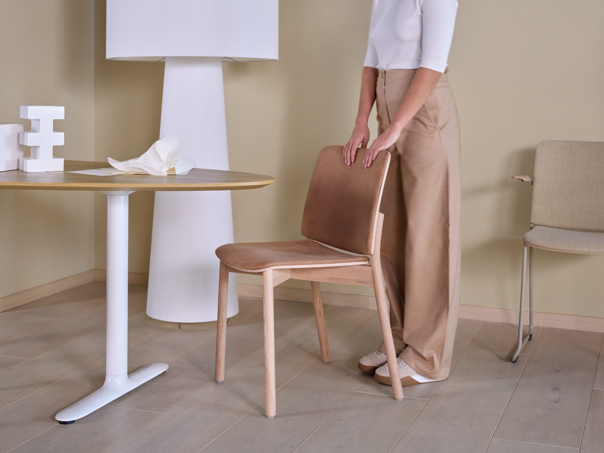 Woman standing behind a chair