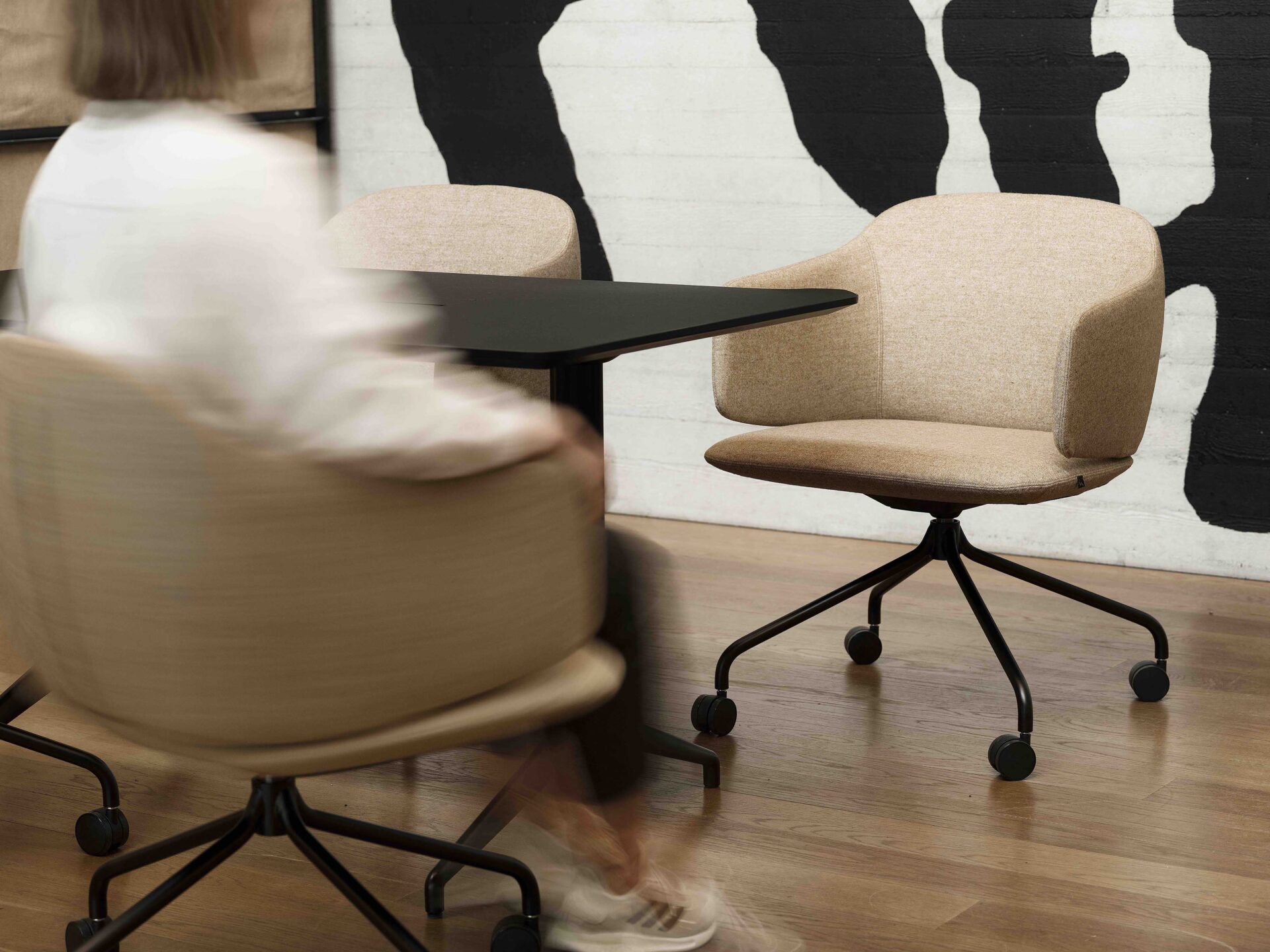 Woman sitting in a chair at a meeting table