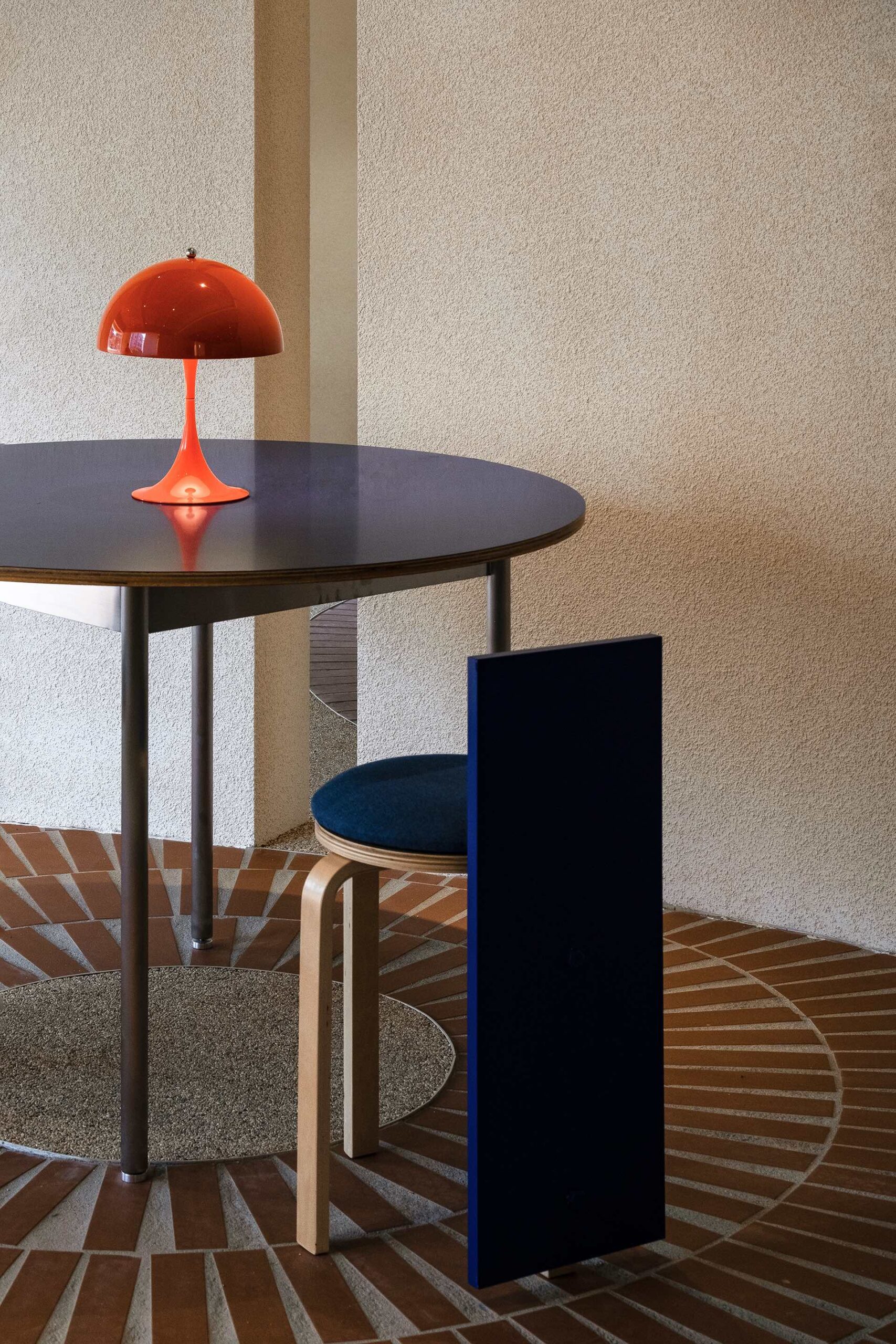 Atelier Ah Cafe Norrri orange lamp on table blue wooden chair
