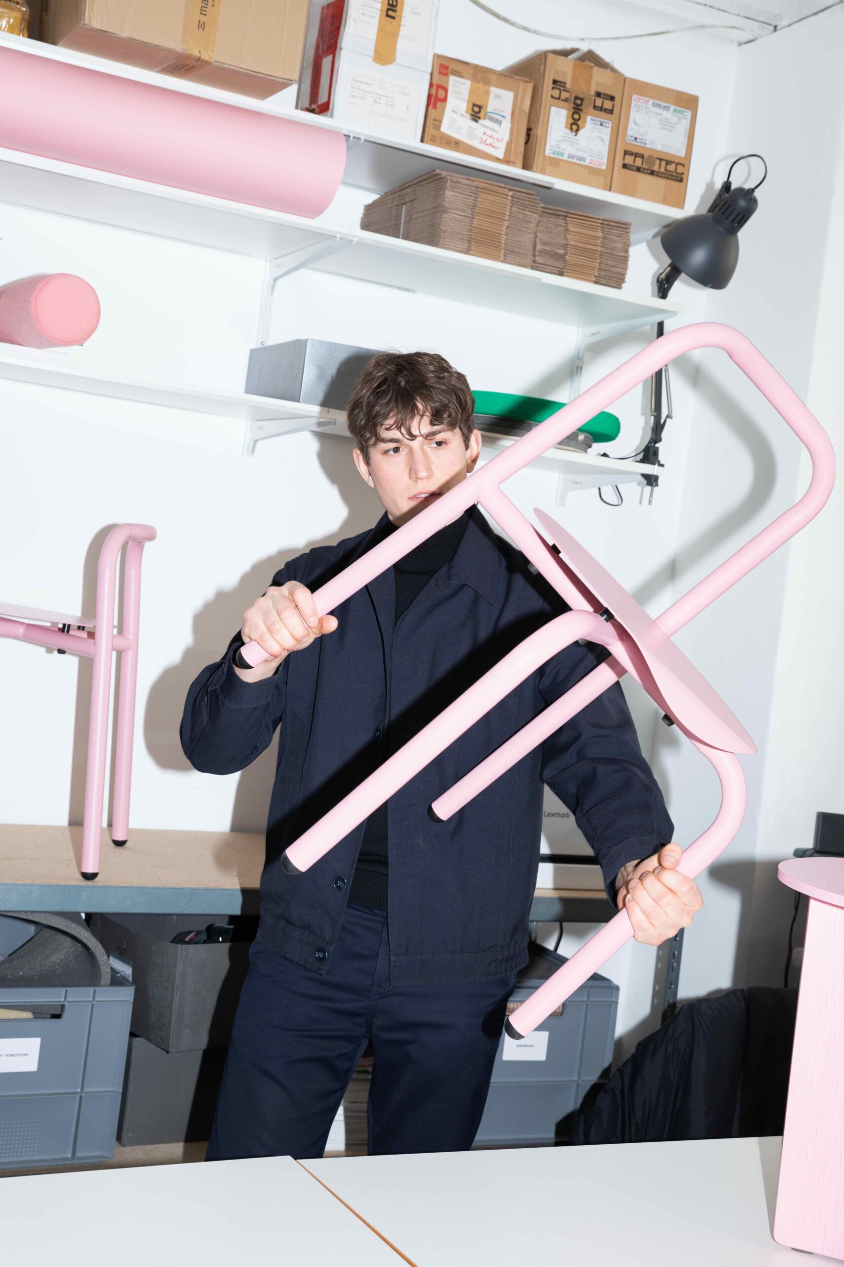 Blockbau founder holding pink chair